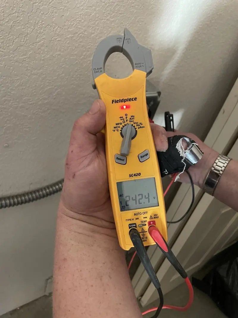 Voltage testing with clamp meter during Ceiling Fan Installation in Bethel
